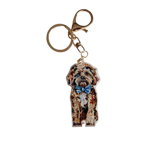 Red Cavapoo acrylic dog bag charm and keychain featuring artwork by Chelsea McShane.